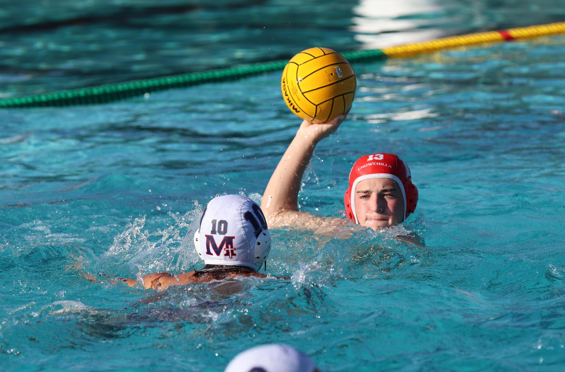 boys water polo players in action against san joaquin memorial