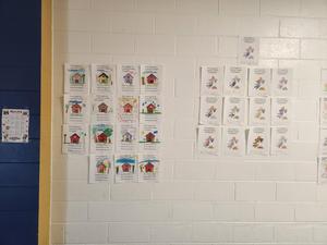 Coloring contest entries hanging on a wall.