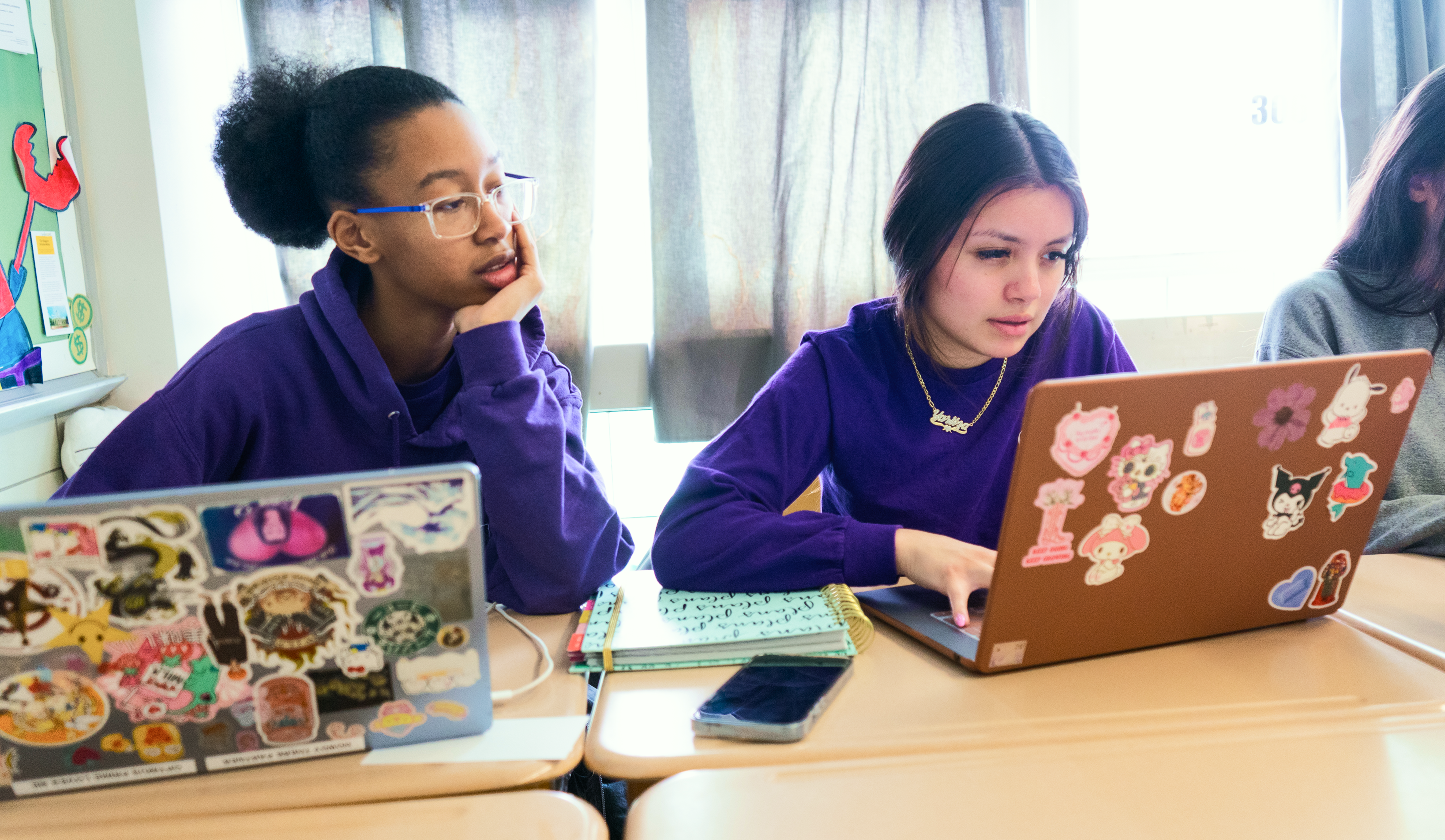 Students sitting in a classroom looking at their computer