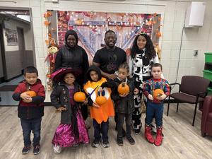 Class taking a photo with their pumpkins