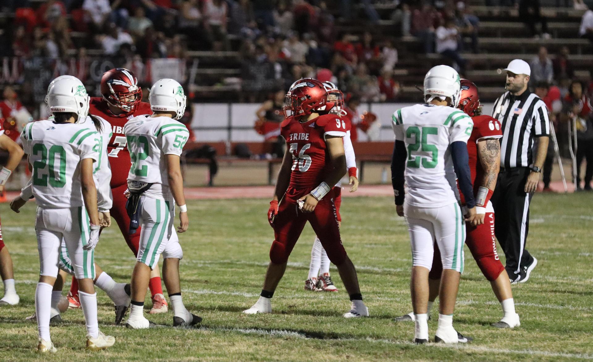 varsity football players in action against Riverdale