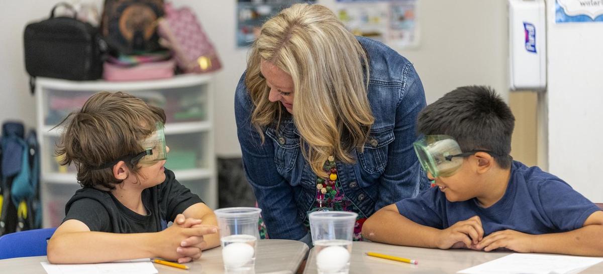 principal with students in science lab