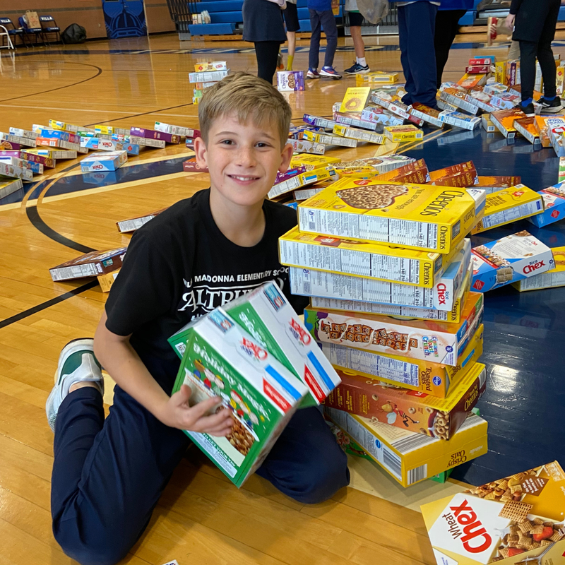 Student sorts boxes of cereal to be donated