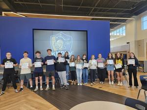 winners standing in line holding certificate in front of knoch logo
