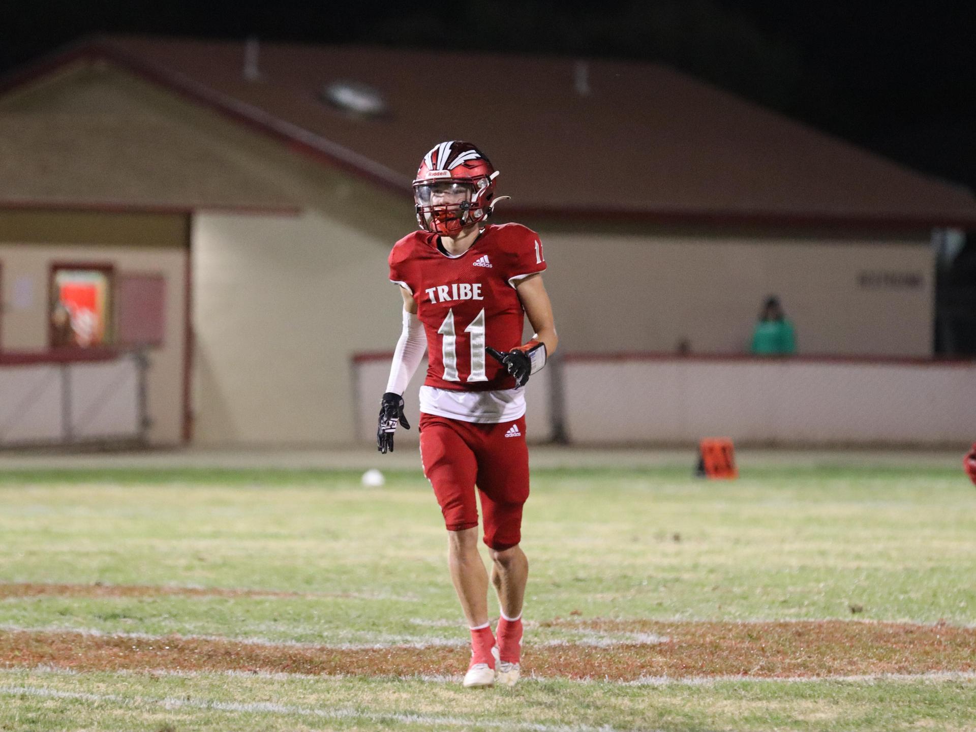 varsity football players in action against Riverdale