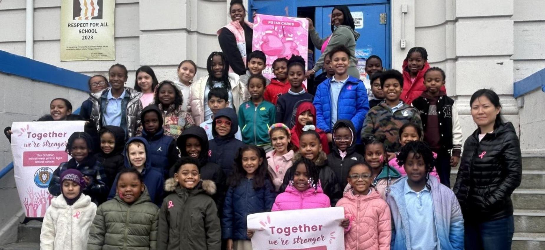 class photo in front of school for breast cancer awareness