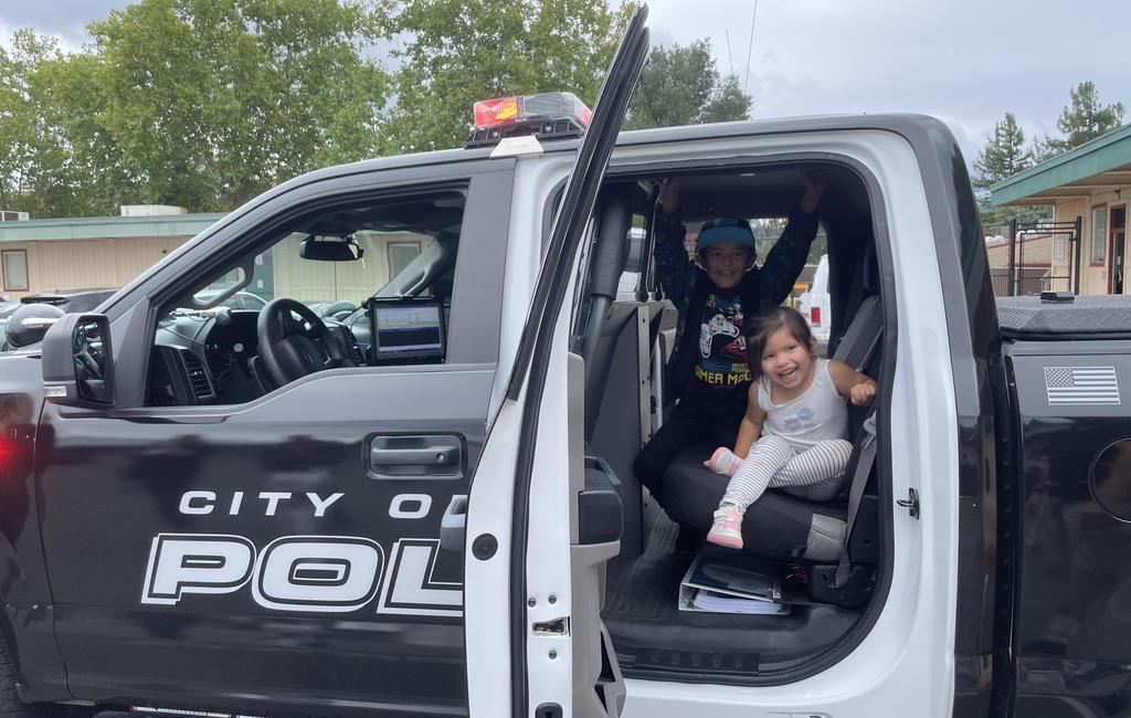 students in police truck