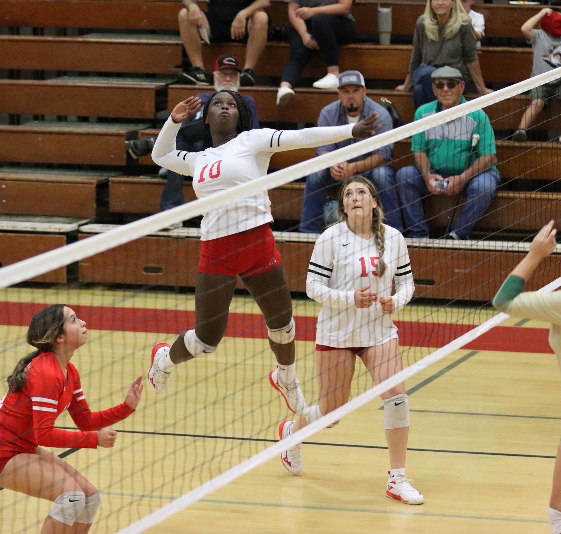 varsity volleyball players in action against liberty