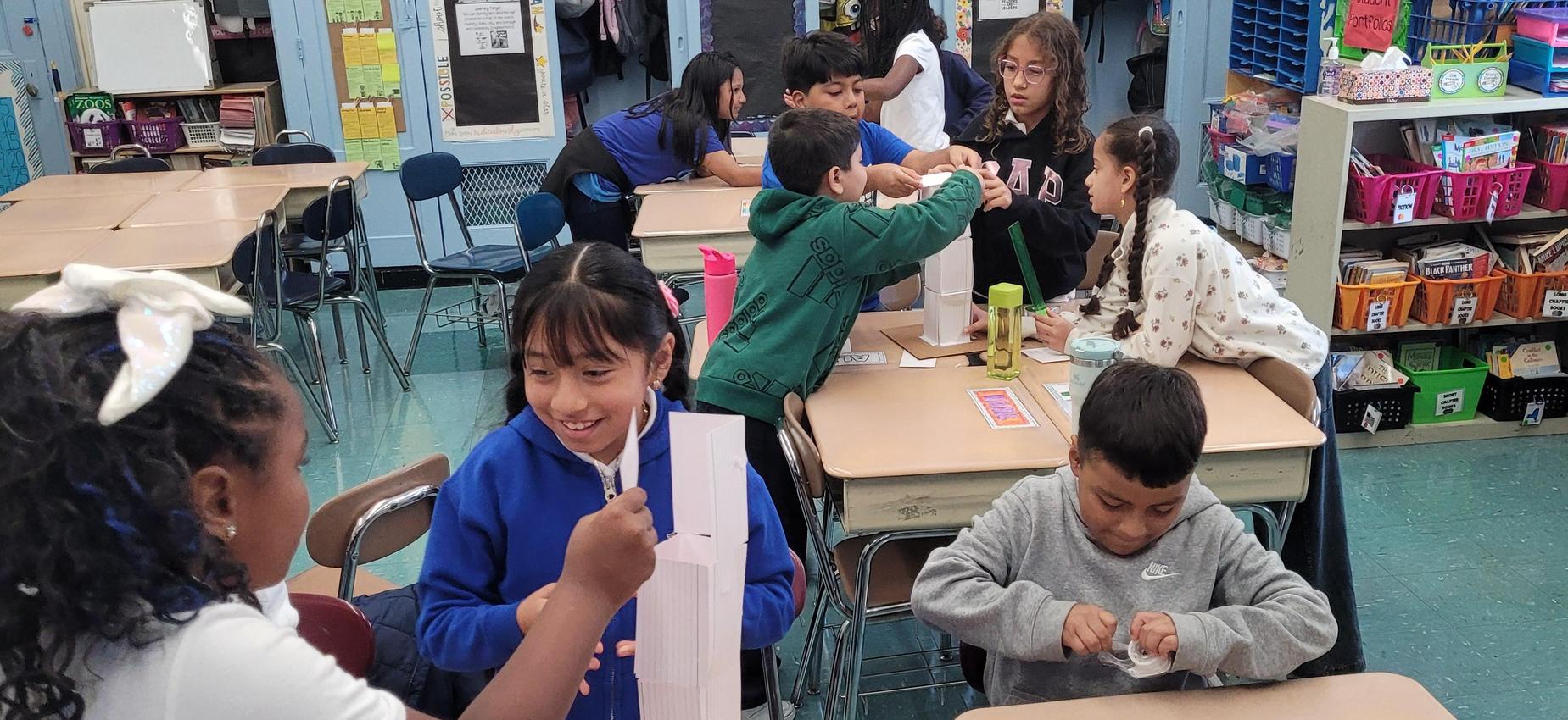 students using school supplies to build towers