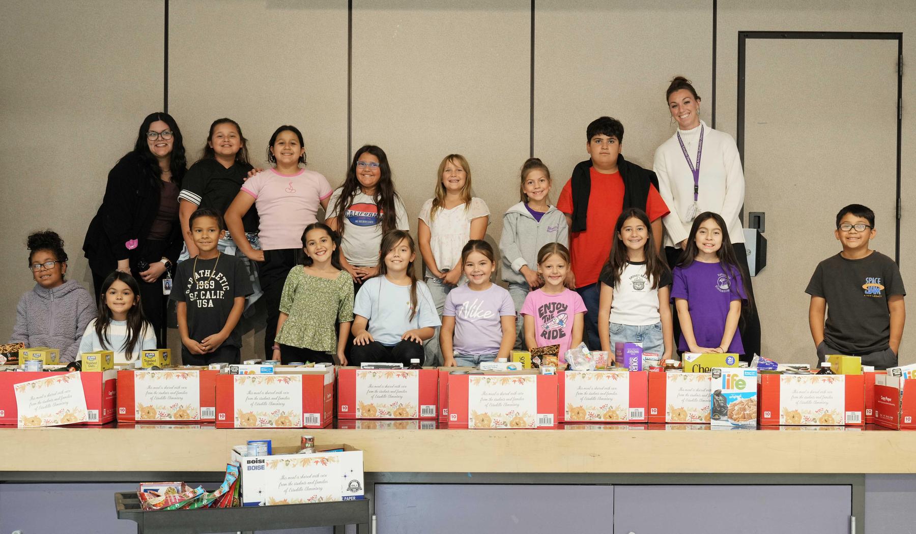 Estudillo Elementary students with boxes of food created after a food drive