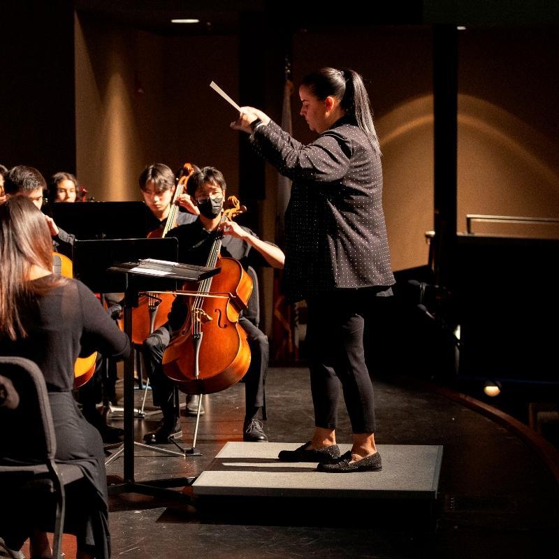 Band director Melissa Romero conducting the high school orchestra