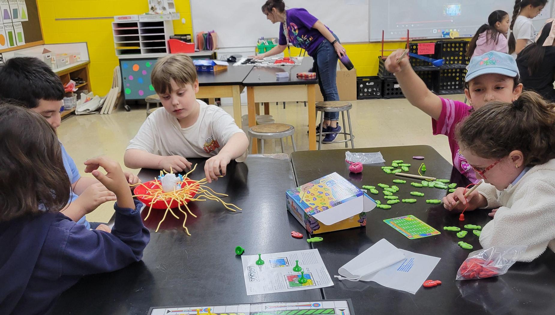 Children engaged in an arts and crafts activity at a table.