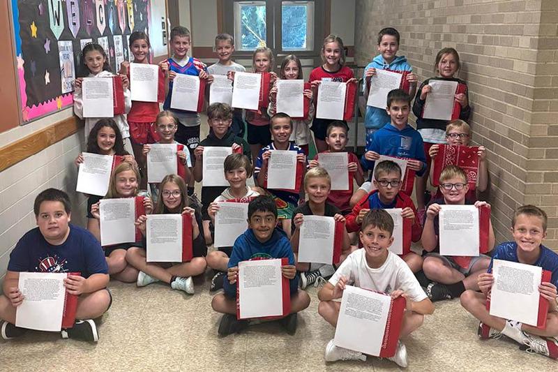 Mr. Pompilio’s homeroom holds their letters and bandanas