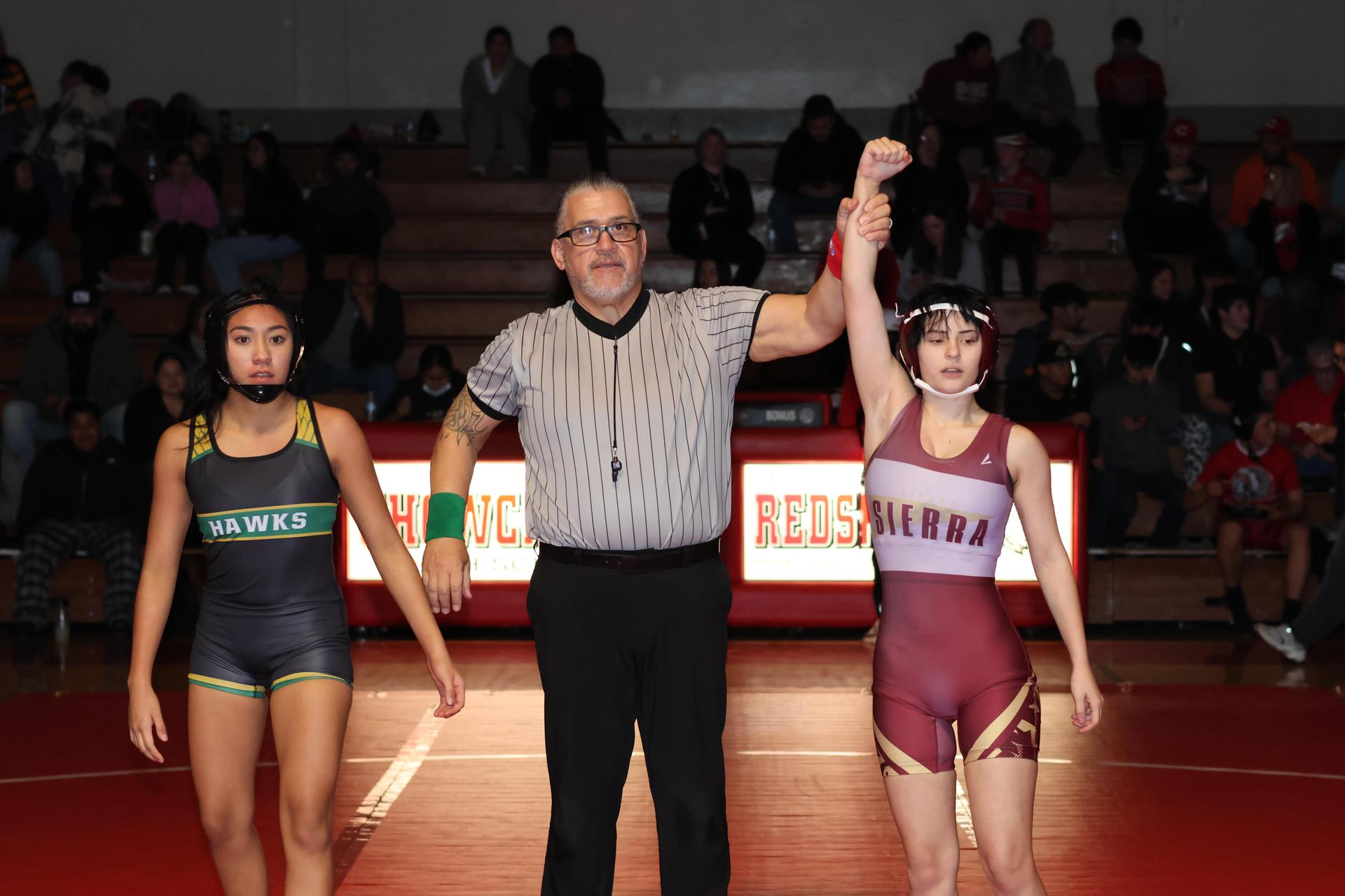 Wrestling winners with hands up 49