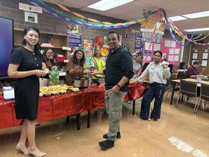 Staff serve nachos at the Nacho Your Cheese teacher celebration