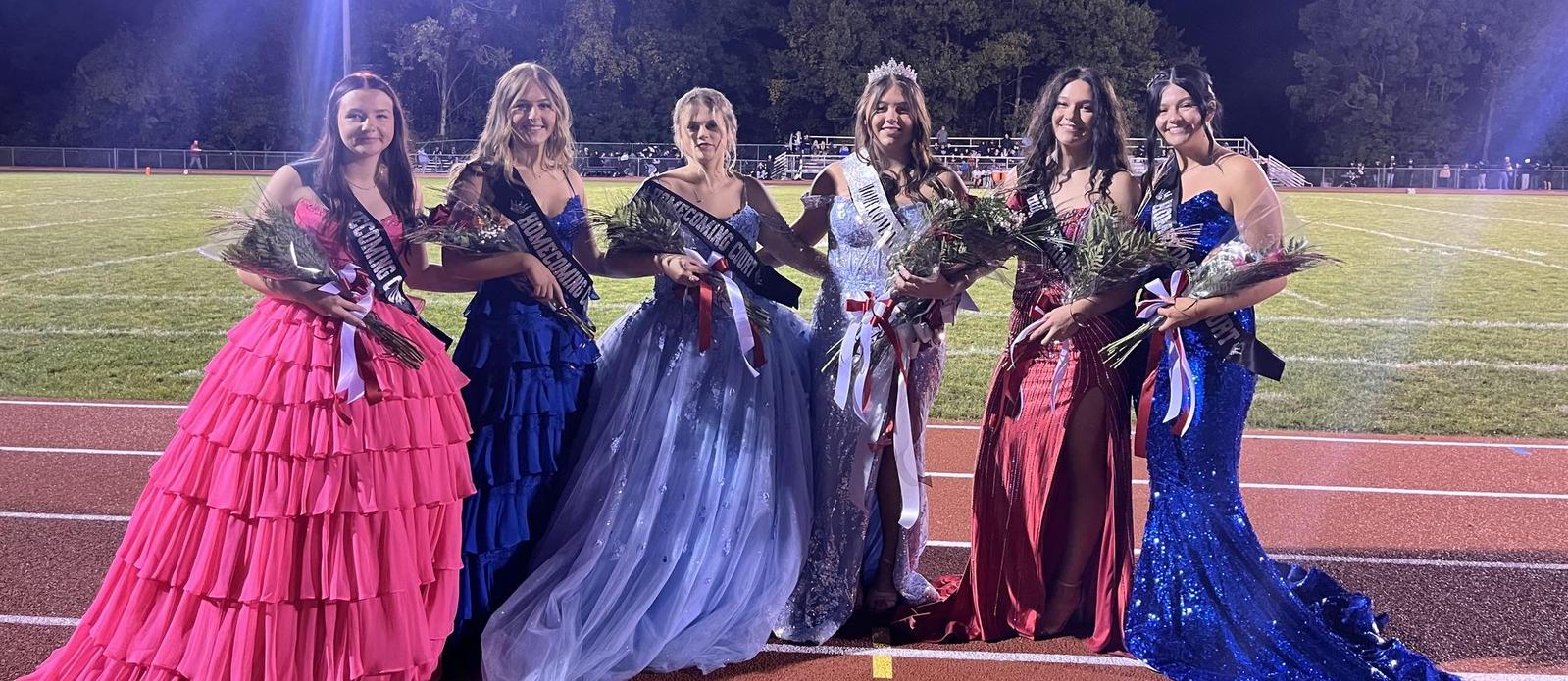 Homecoming Court girls in their gowns at the football game