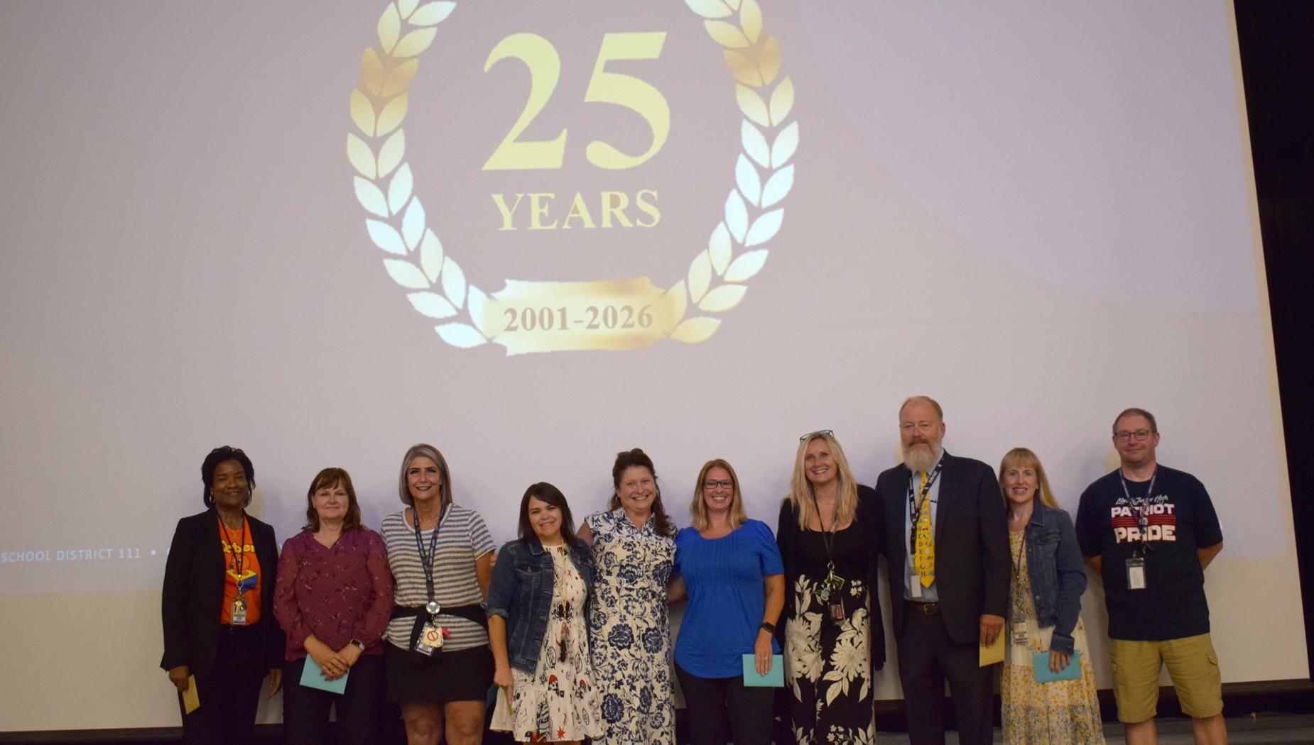 Celebration of 25 years with a group of people on stage.