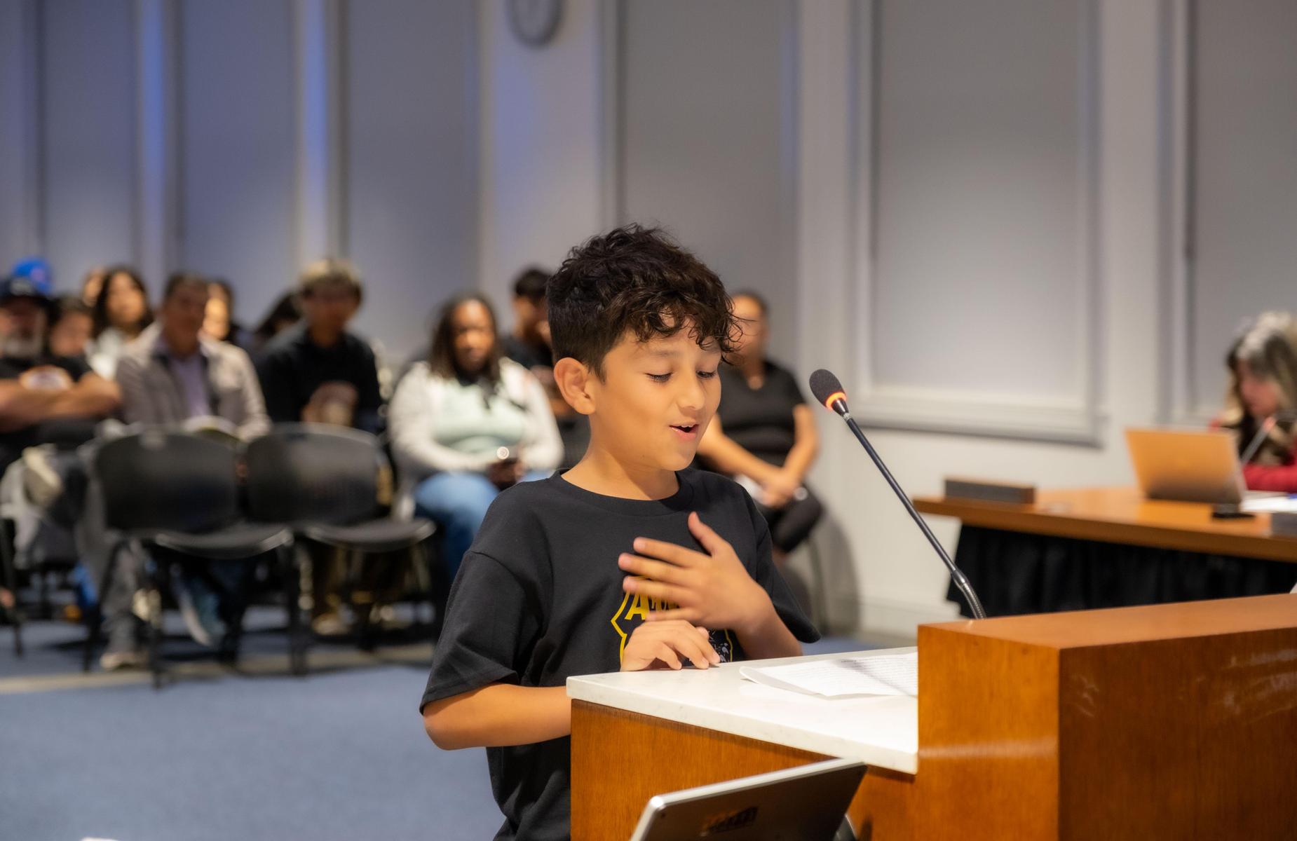 one student with left hand over heart