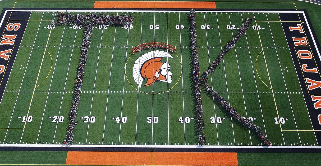 TK staff create a giant "TK" on the football field.