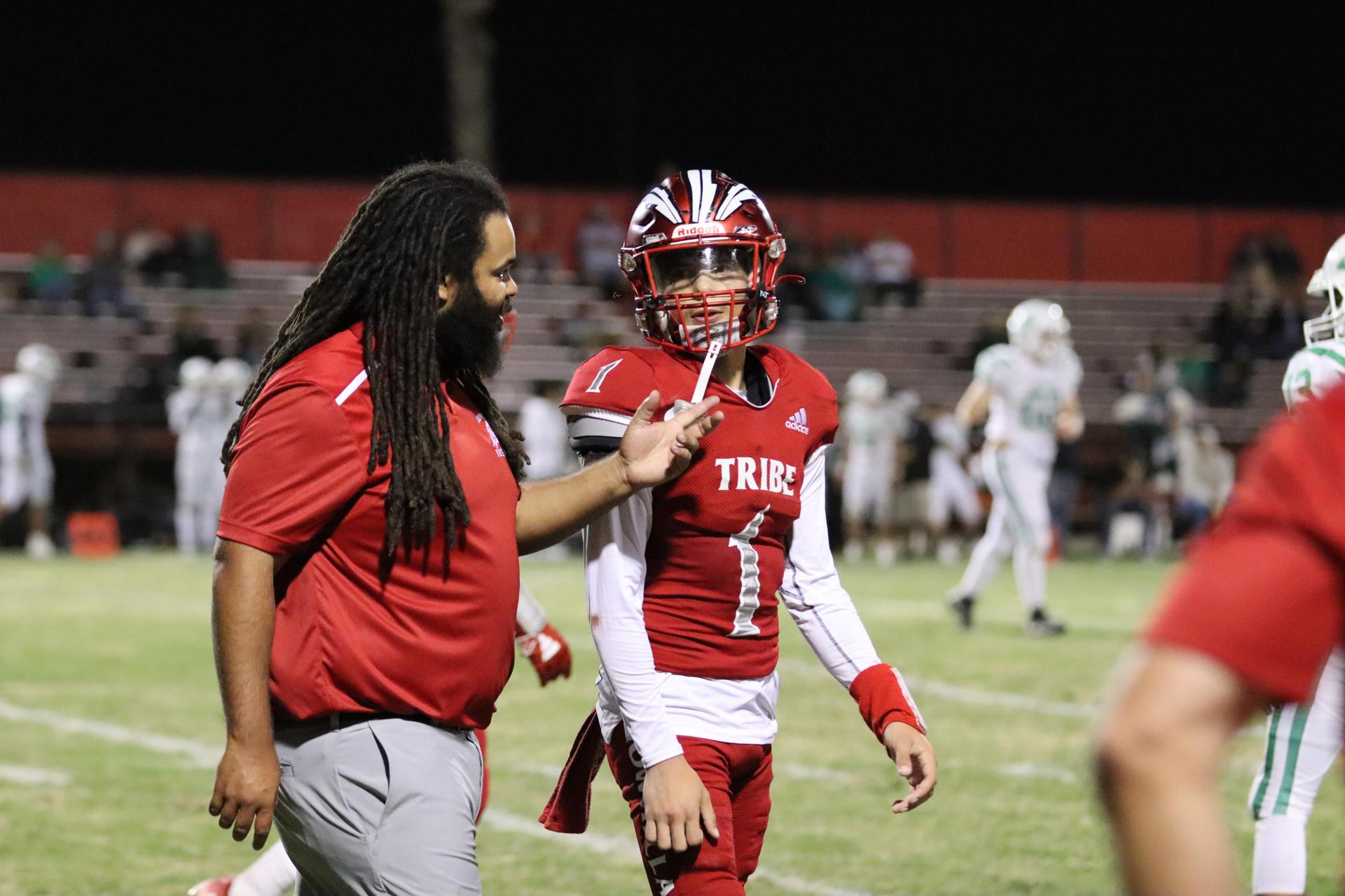 varsity football players in action against Riverdale