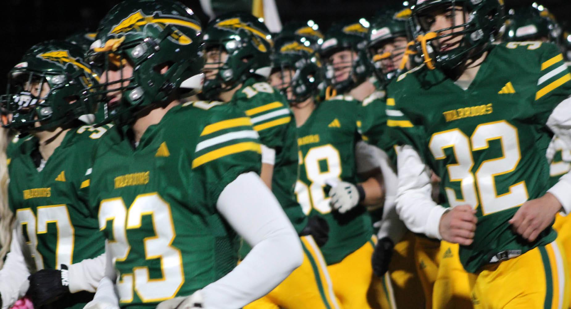 The football team enters the field for a game