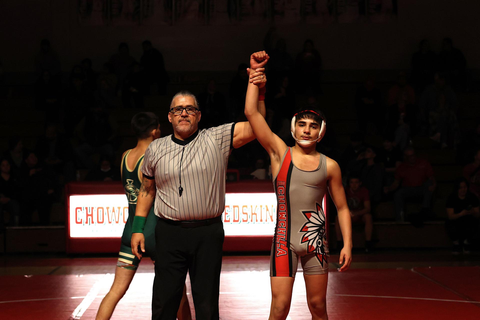 Wrestling winners with hands up 118