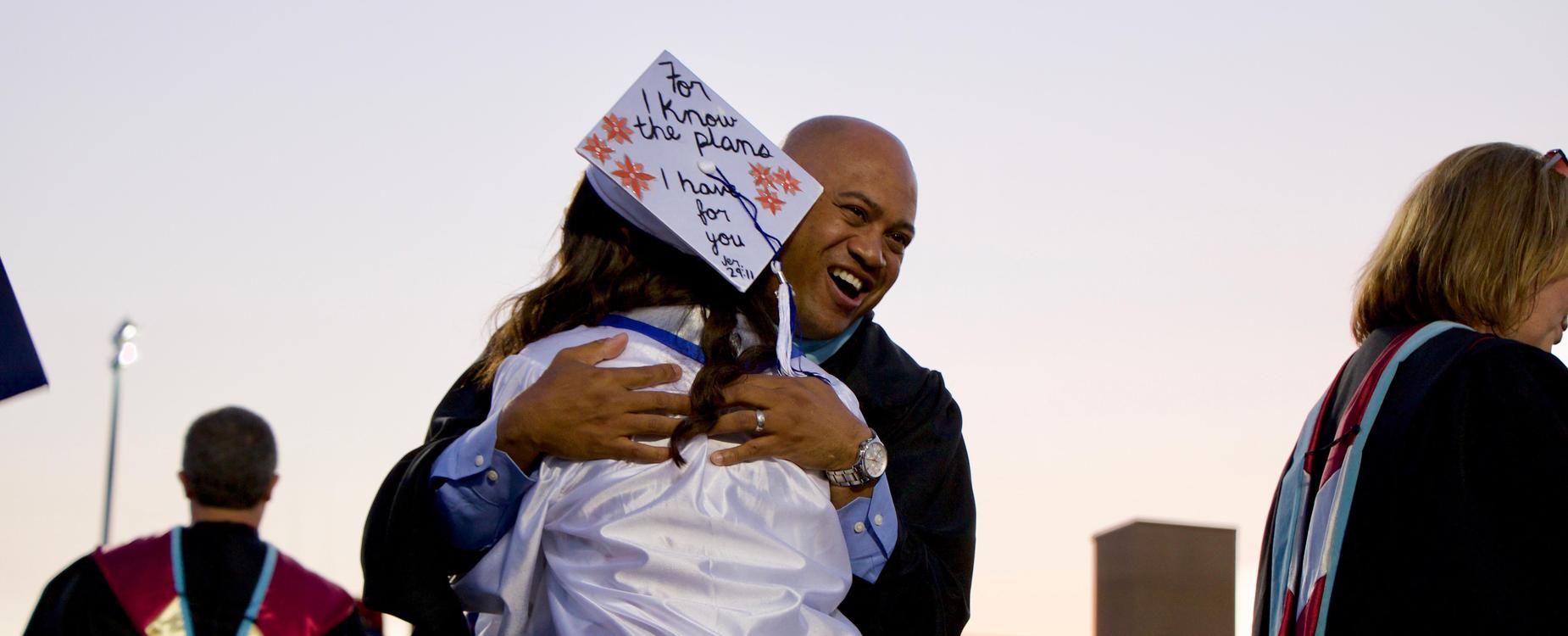 Mr. Davis hugging graduate