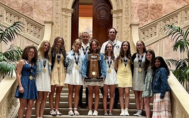 Girls cross country team at the state capital accepting award.