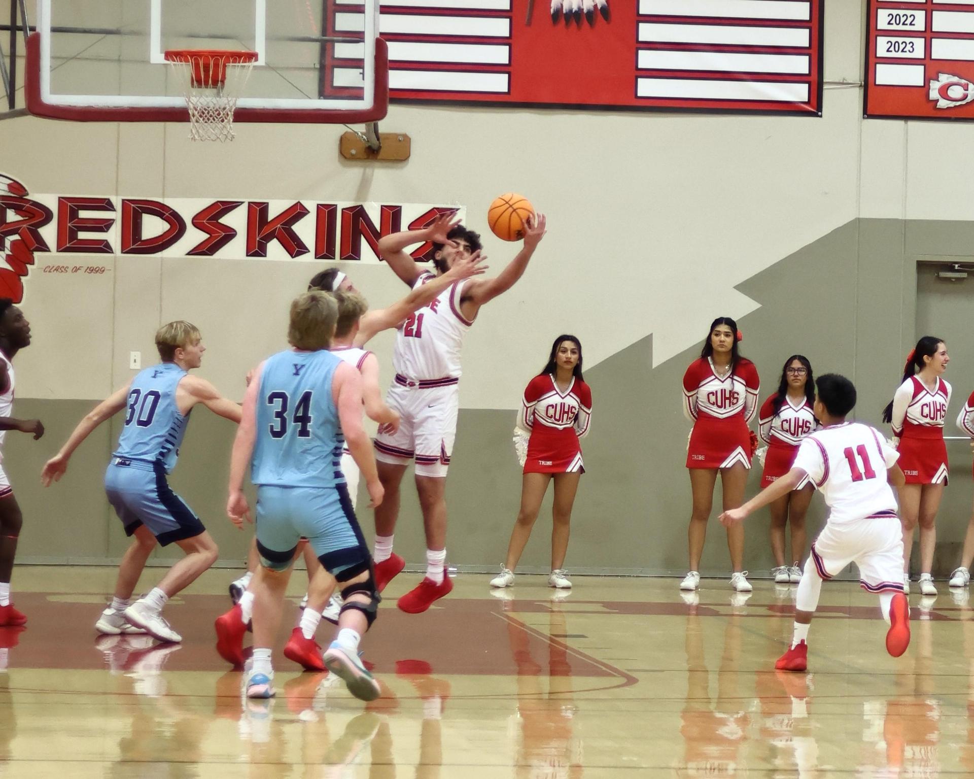 Varsity boys playing basketball against yosemite