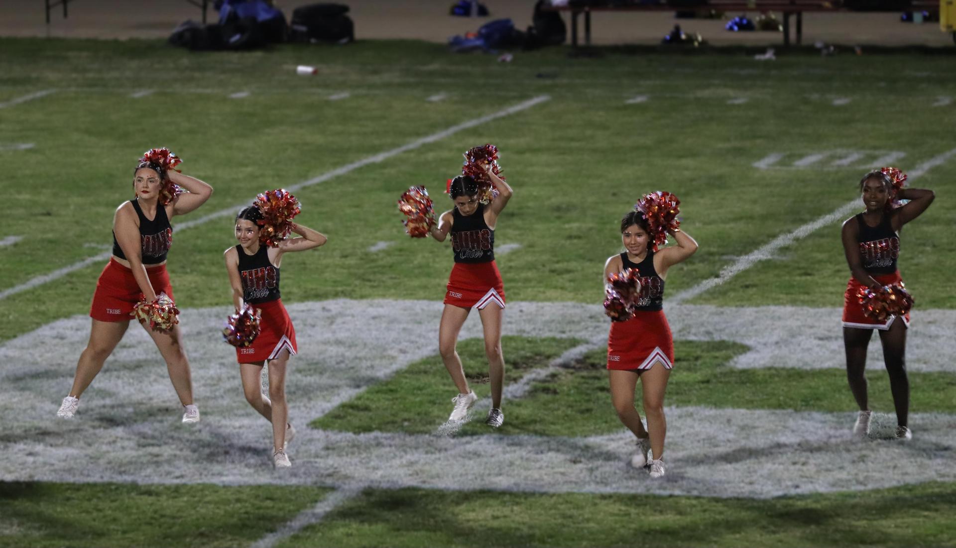 Varsity girls cheering at the Parlier football game