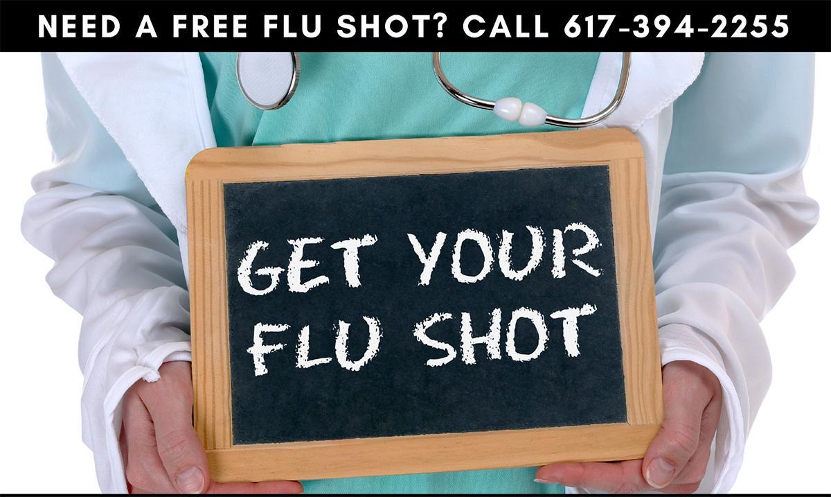Doctor holding a flu shot sign on a chalkboard
