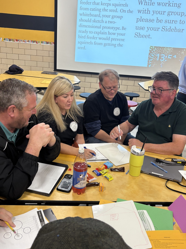 Teachers working together around a table during professional development