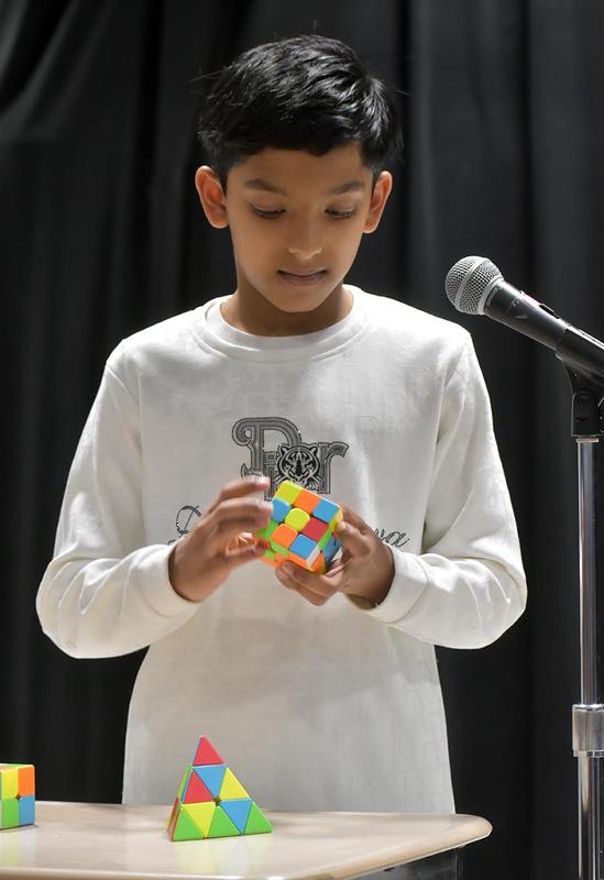 a boy playing with a Rubik's cube