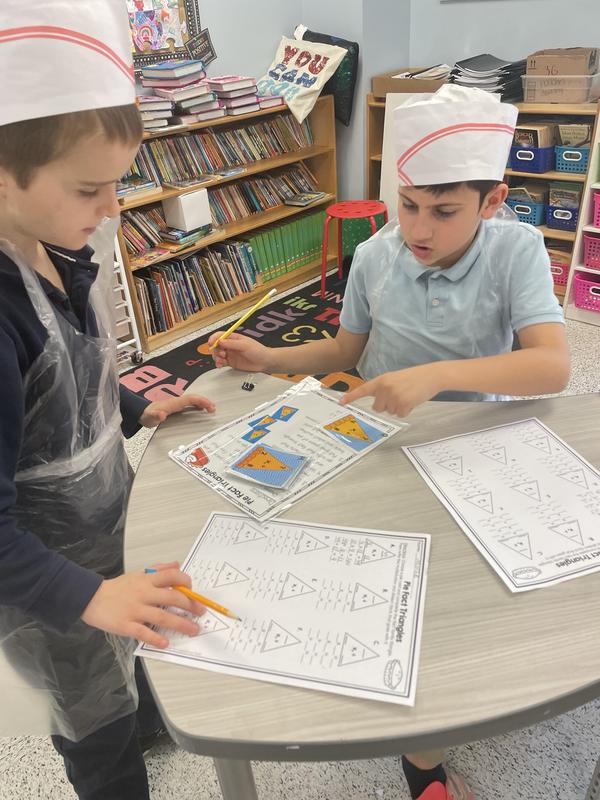 two boys working together at the math  bakery.
