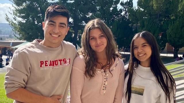 Three students looking into the camera