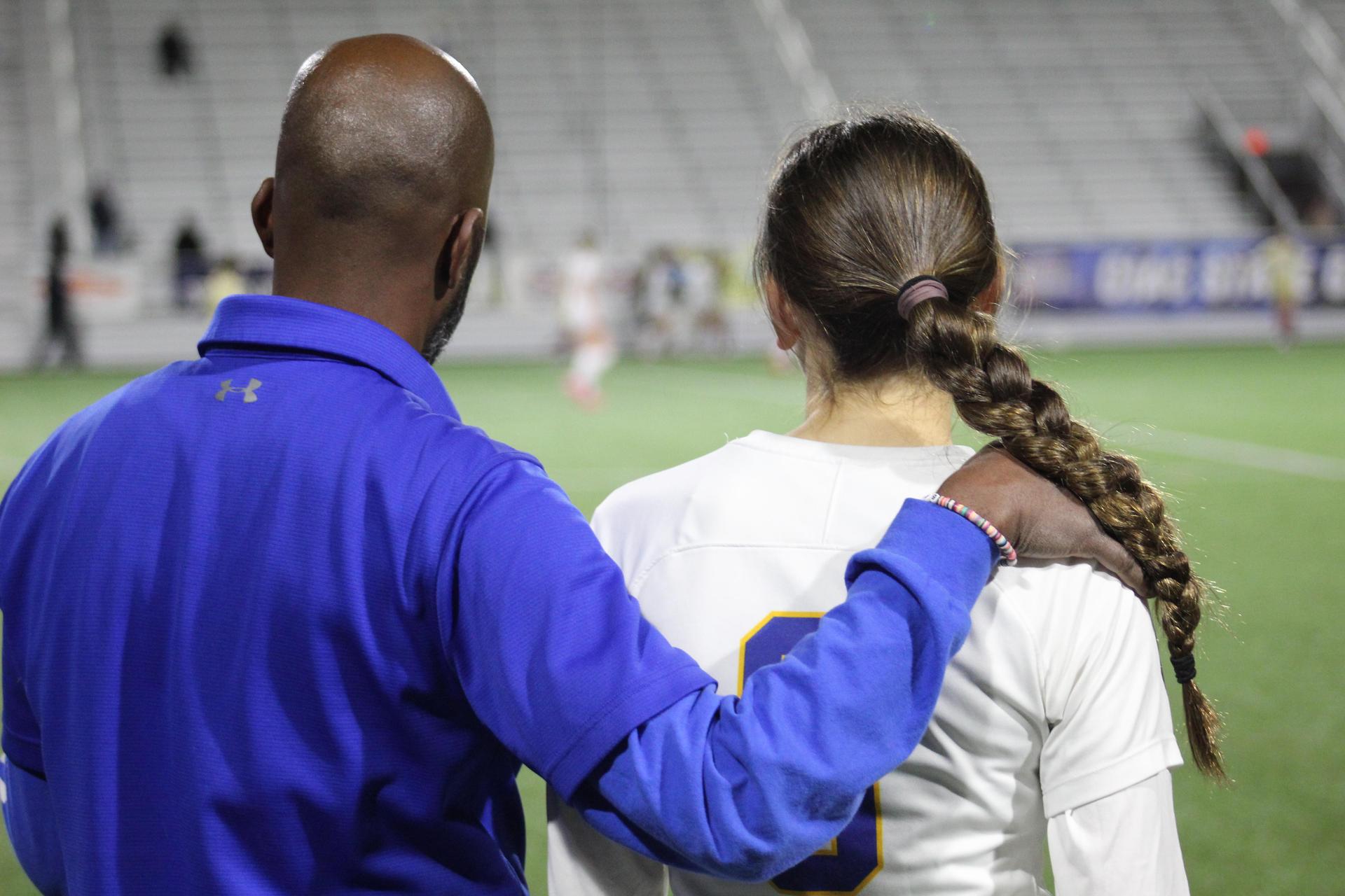 Coach and athlete share a moment