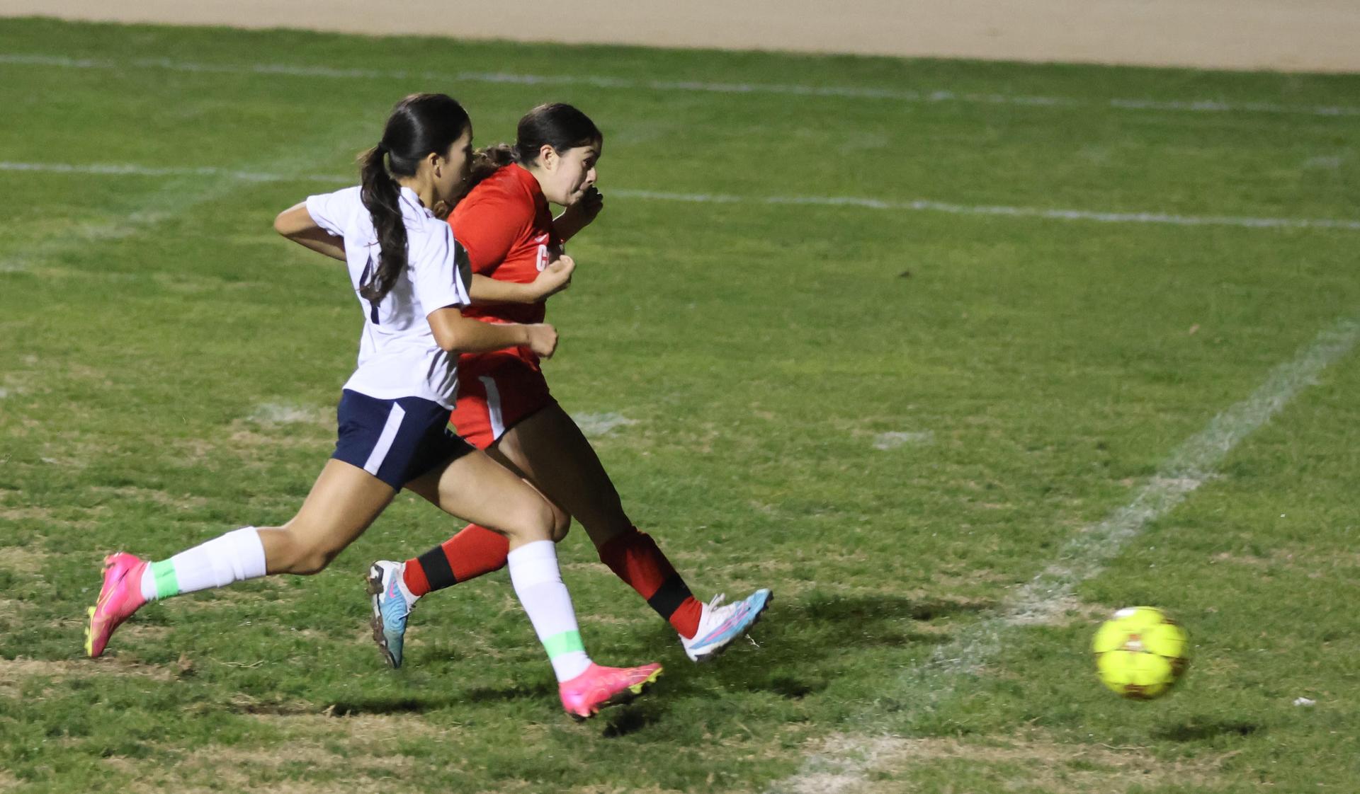Varsity girls playing soccer against sunnyside