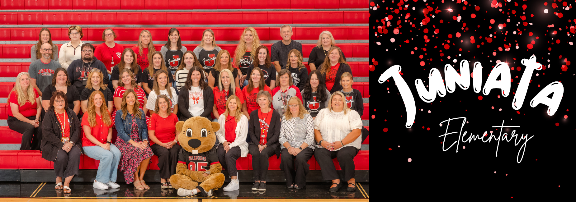 Group portrait of staff and a mascot at Juniata Elementary School.