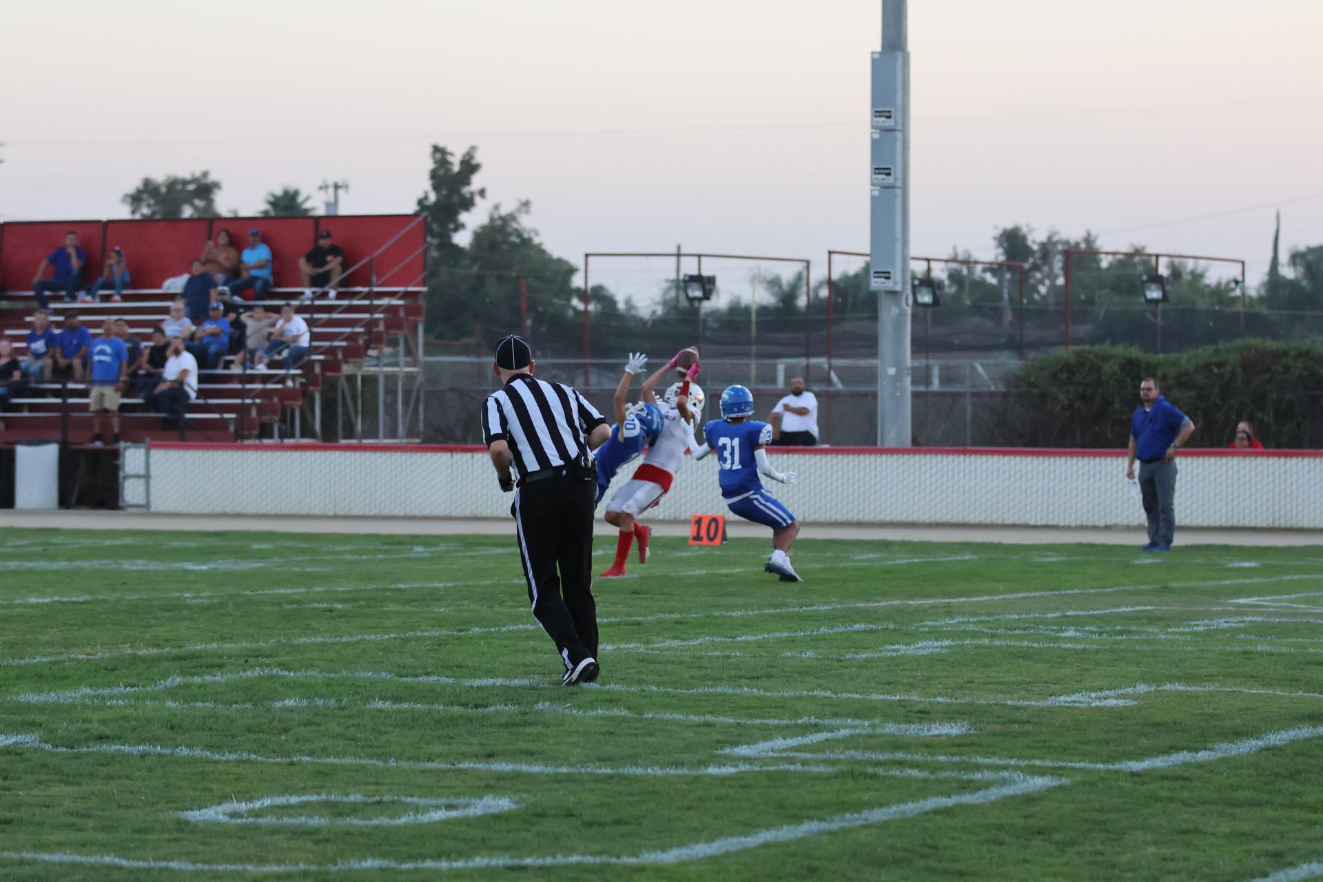 Junior Varsity football players in action against Caruthers