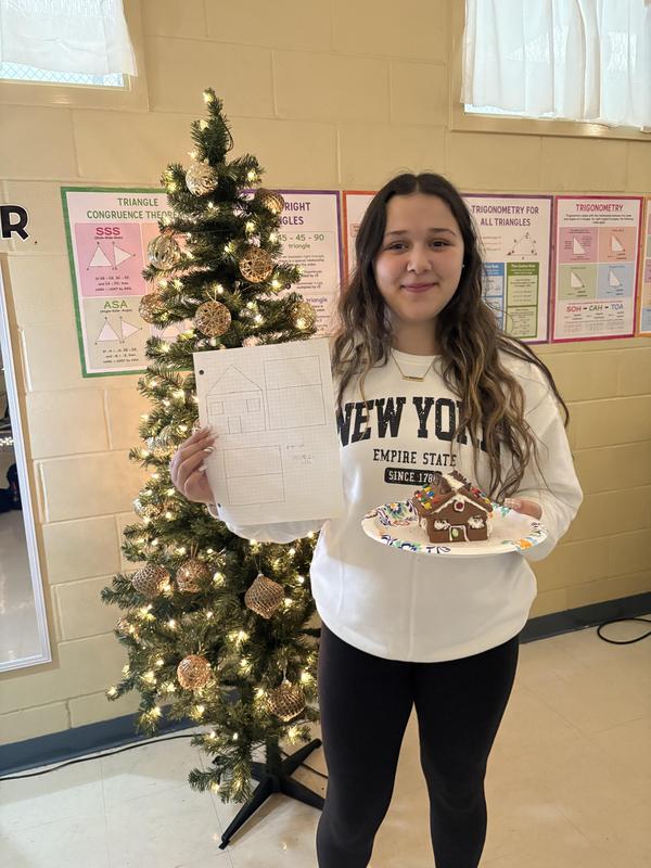 one student with gingerbread house with plans