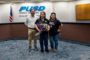 three people posing in the governing board room