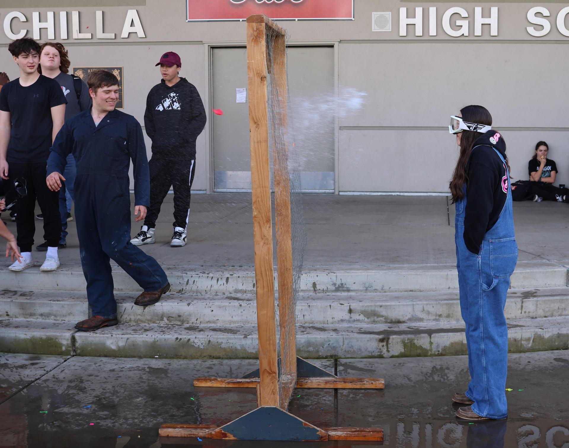 students and staff enjoying the water balloon toss