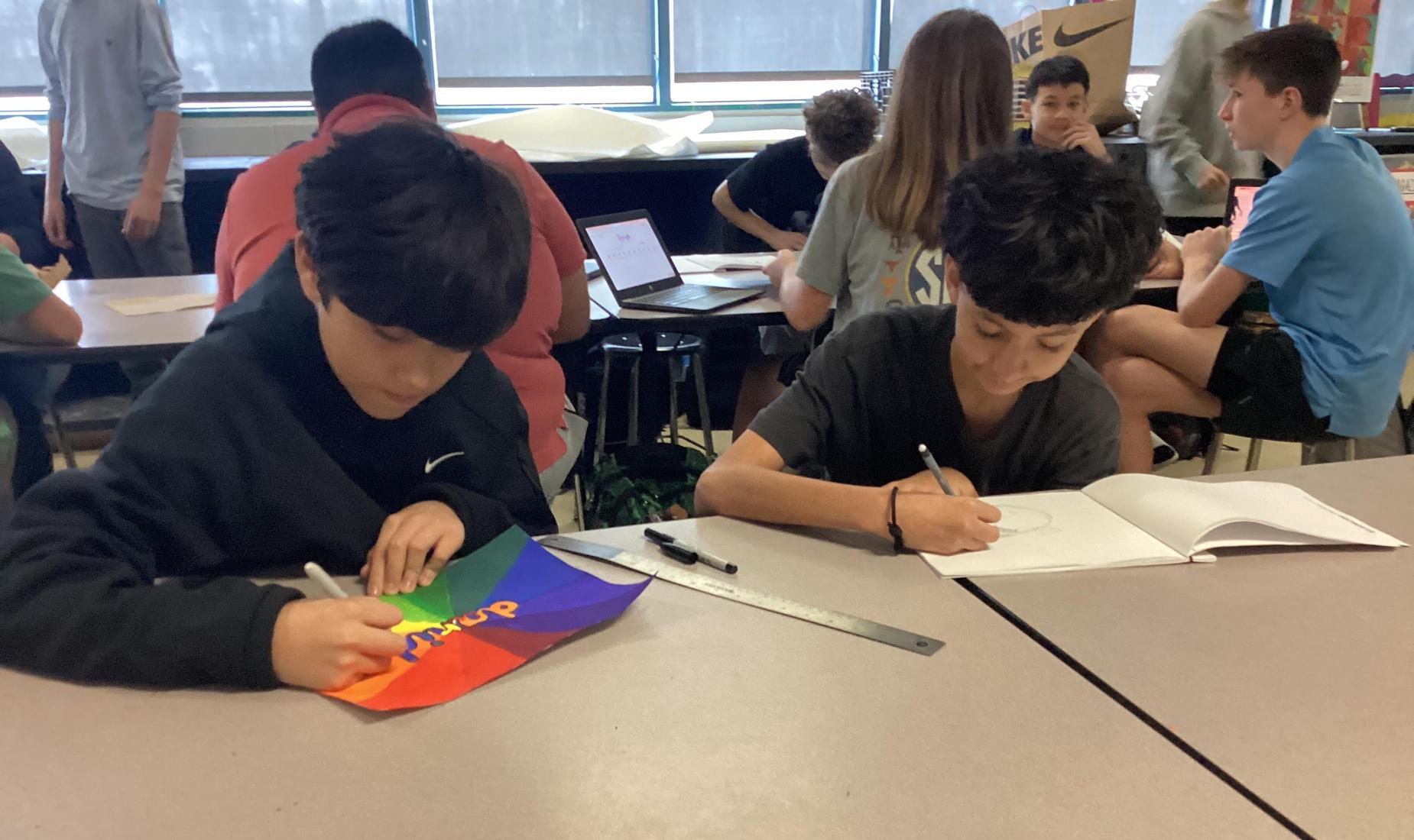 2 students work on their art projects