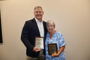 Photo of Debbie Nance & Randall Morgan with awards honoring their years of service