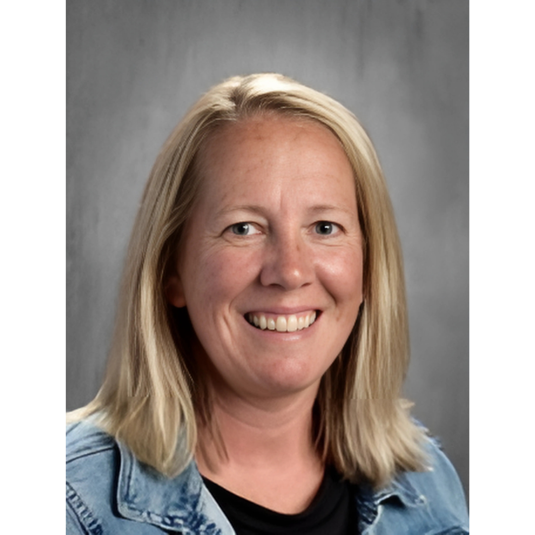 a person with blonde hair wearing a denim jacket