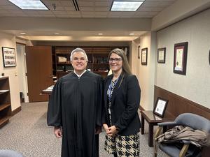 Dr. Grantz in dress alongside a judge in his robe