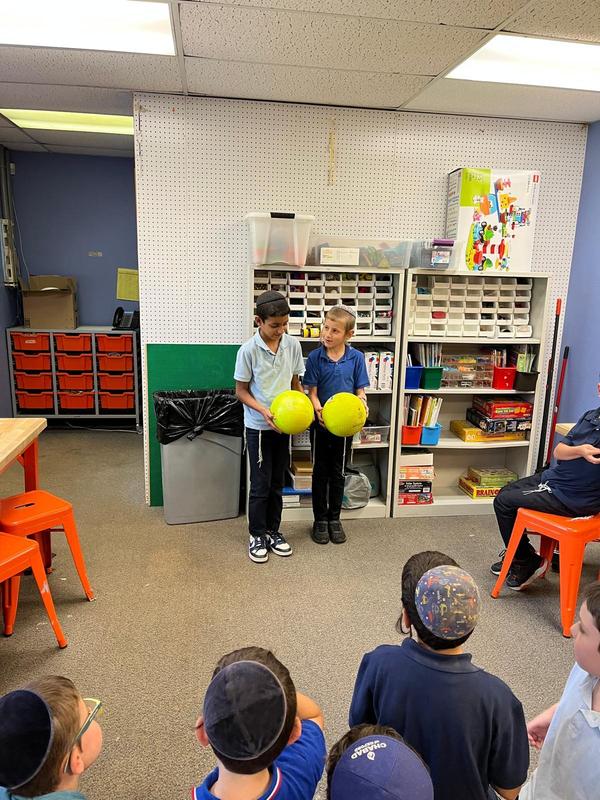 Two second grade boys prepare to test gravity.
