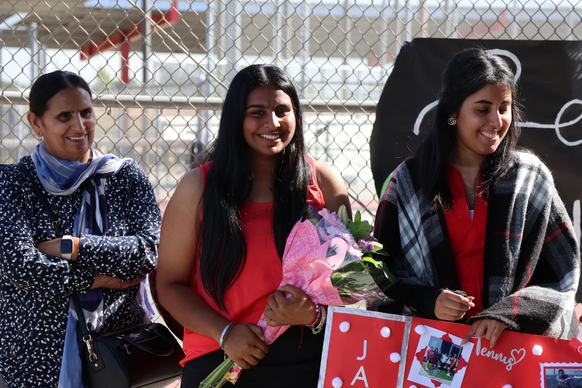 tennis players, family, and staff celebrating senior night