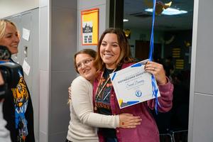 Sarah Denning hugging students