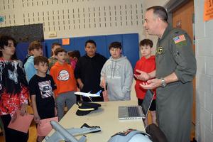 A military officer talks to students about aviation careers.